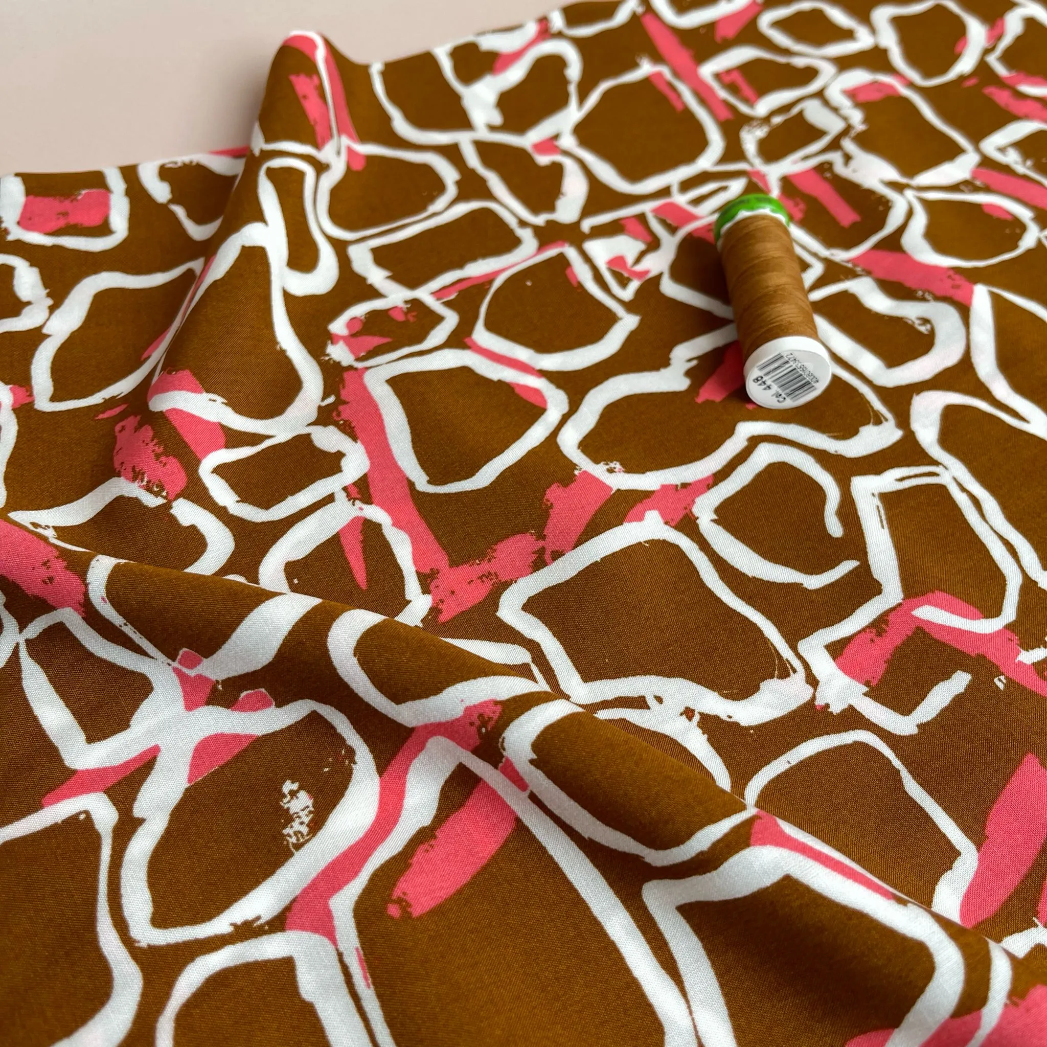 White Shapes on Brown Viscose Fabric
