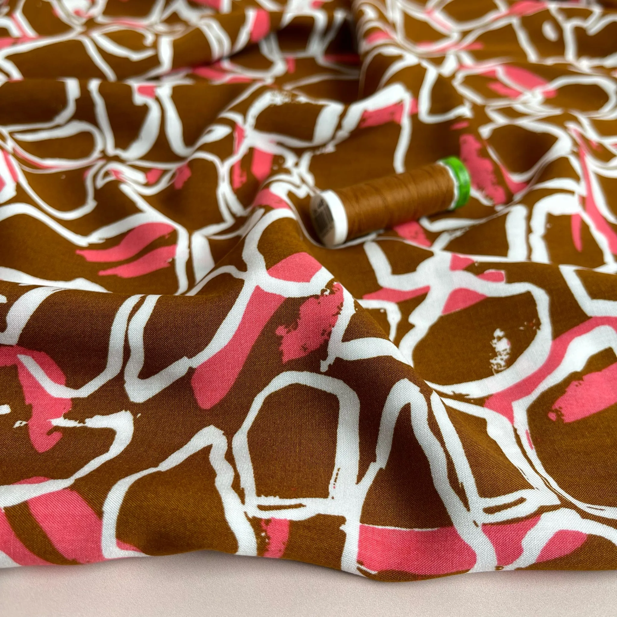 White Shapes on Brown Viscose Fabric