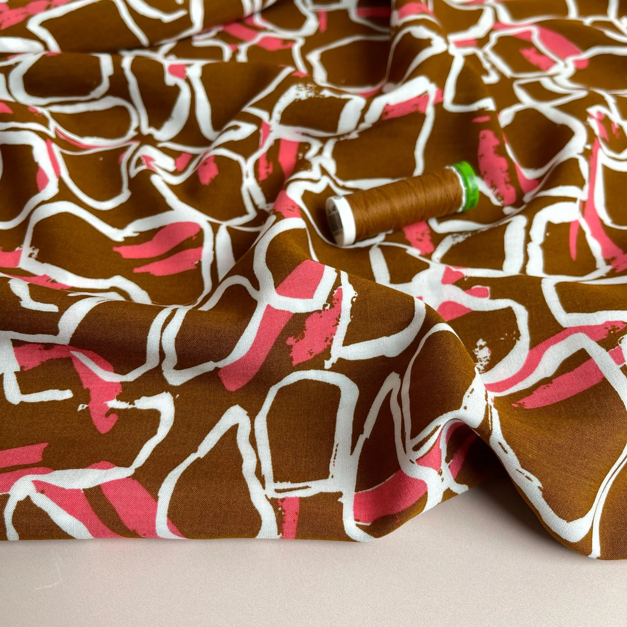 White Shapes on Brown Viscose Fabric