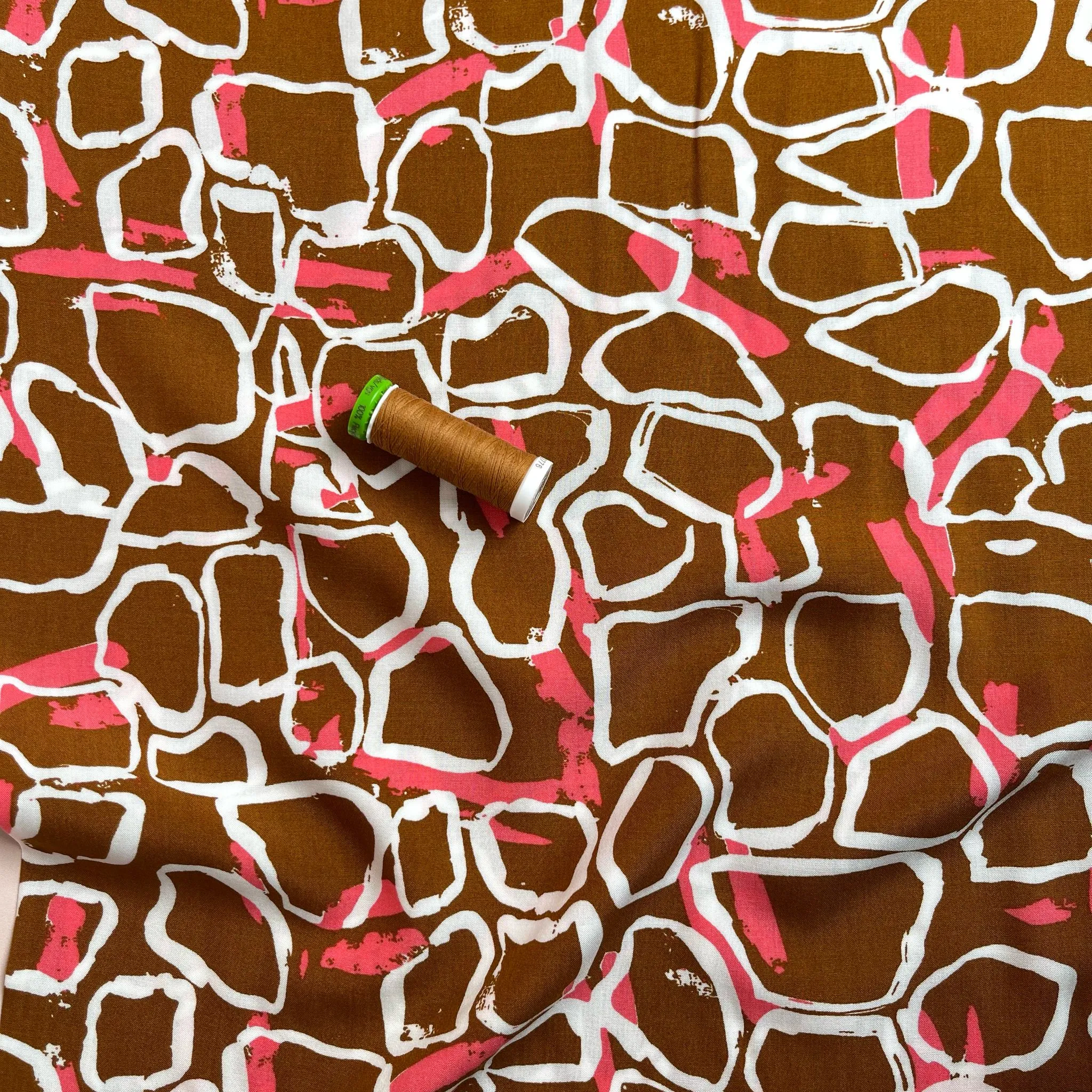 White Shapes on Brown Viscose Fabric