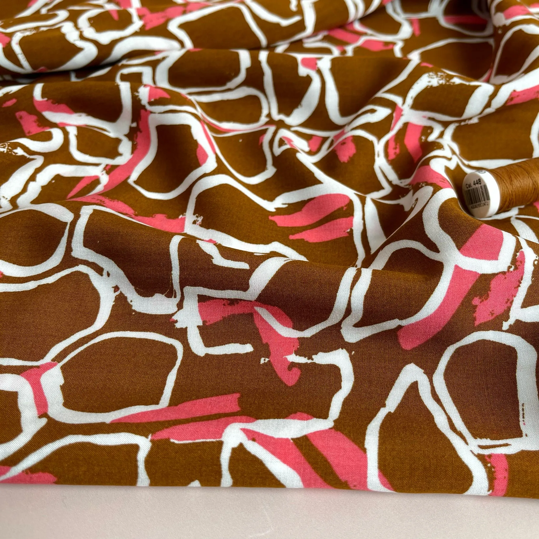 White Shapes on Brown Viscose Fabric